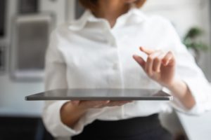 Artificial Intelligence System. Businesswoman Holding Digital Tablet And Pointing Finger Or Pressing Invisible Button - Contabilidade em Lages - SC | Fibonacci Contabilidade